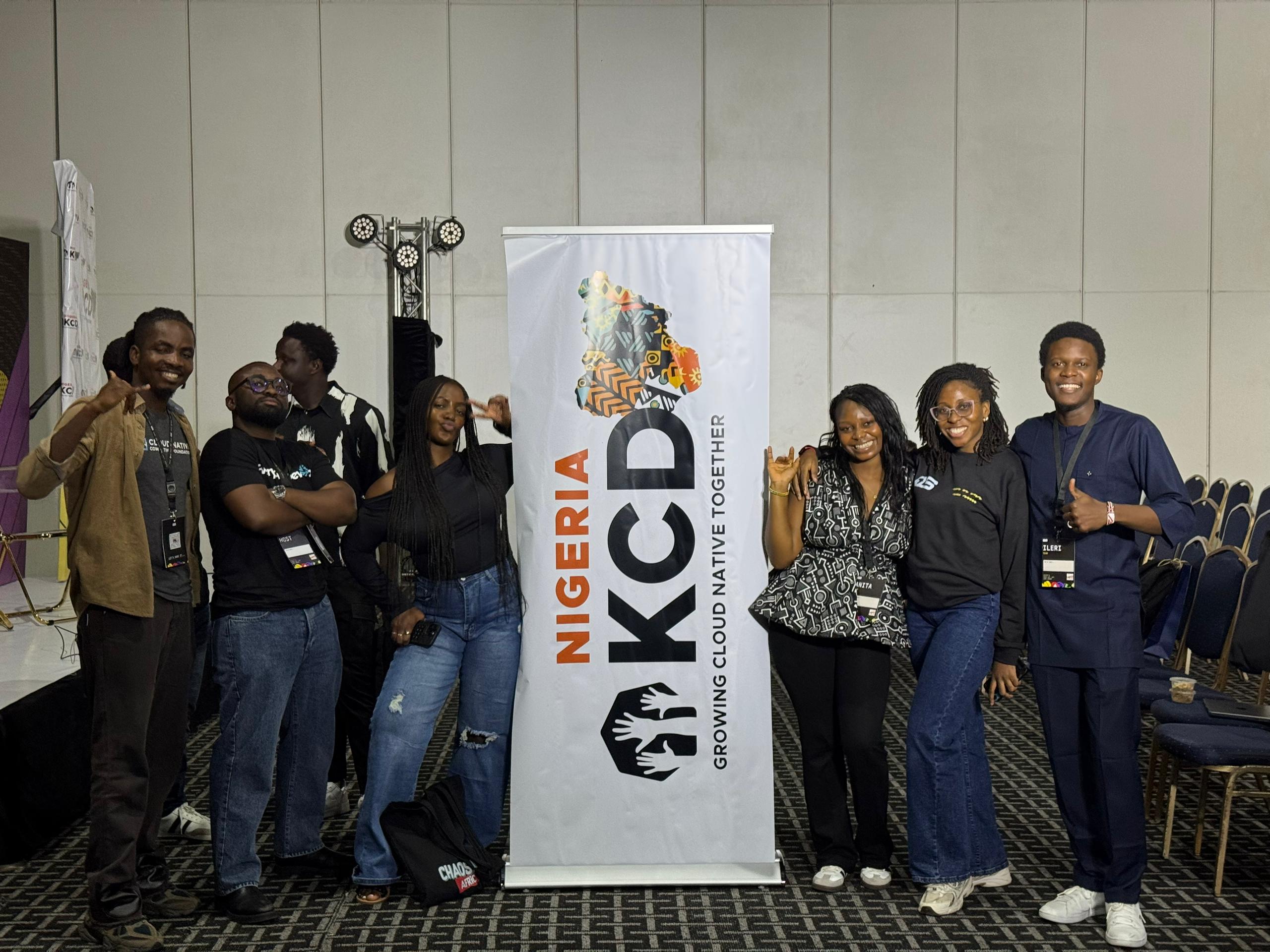 KCD Nigeria 2025 organizers and volunteers posing beside the KCD Nigeria banner
